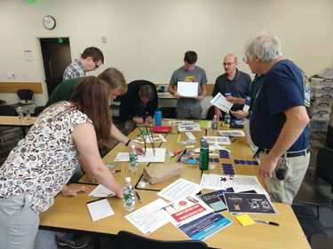 Team members participate in an activity at a table