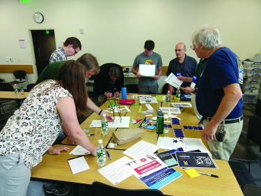 Team members participate in an activity at a table